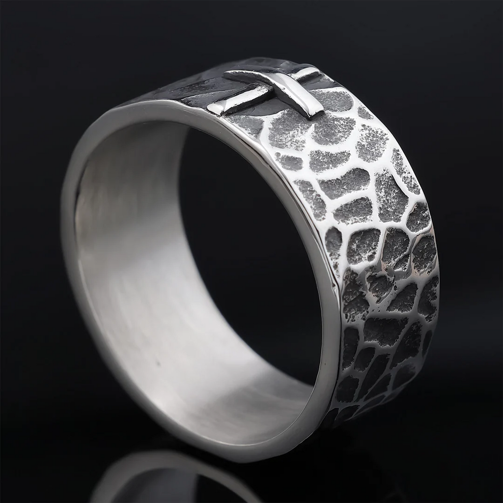 Hand-carved stone cross ring carries His gentle protection