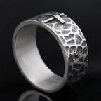 Hand-carved stone cross ring carries His gentle protection